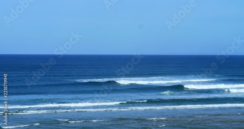 A man paddle-foil surfing a large swell