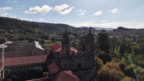 Historic poio monastery building standing among vineyards and green hills of galicia
