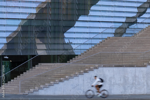 Silhouette of a cyclist against the backdrop of a modern building