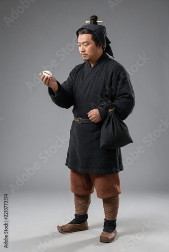 Chinese Qin Dynasty Trader Holding Cowrie Shells at Market