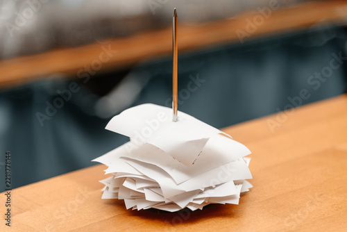 pile of spiked papers, restaurant and bar checks with orders on bar counter