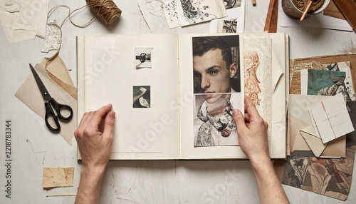 Hands Creating Scrapbook with Photos and Paper Collage