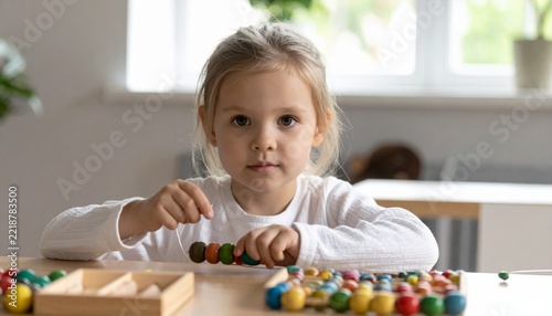 Child Practicing Fine Motor Skills with Colorful Beads