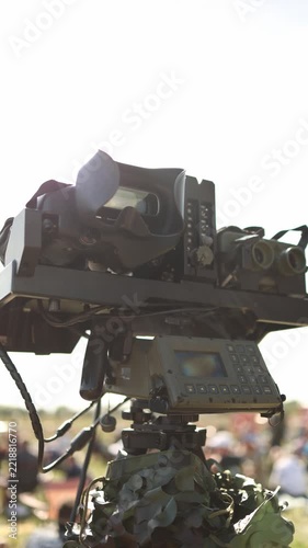 Vertical screen Military optical surveillance system with binocular sensors and digital control panel mounted on a camouflaged observation platform for reconnaissance and monitoring