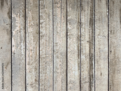 Weathered vertical wooden planks with peeling paint, textured rustic background