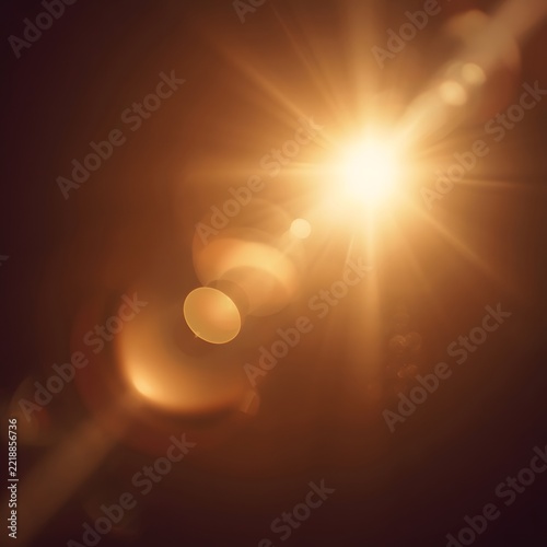 Bright sunburst star with intense warm lens flares on dark golden brown background.