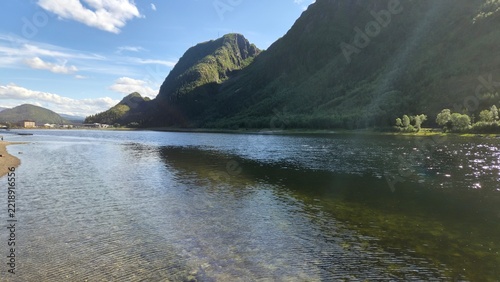 Scenic view of a river surrounded by mountains in a natural setting