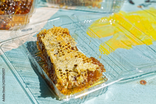Fresh cut honeycomb with raw honey on work surface