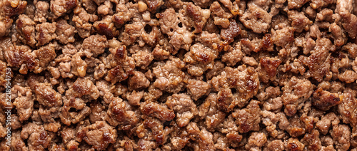 Minced beef meat cooked brown texture background for culinary recipes and food projects