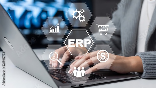 Businesswoman using laptop with ERP Enterprise Resource Planning virtual interface icons