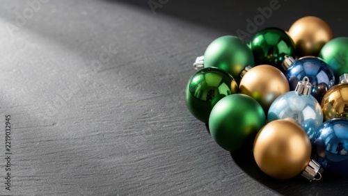 elegant collection of reflective christmas ornaments on dark slate for upscale holiday advertising background