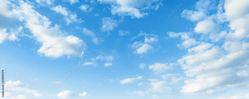 Fototapeta premium Clear blue sky with scattered fluffy white clouds