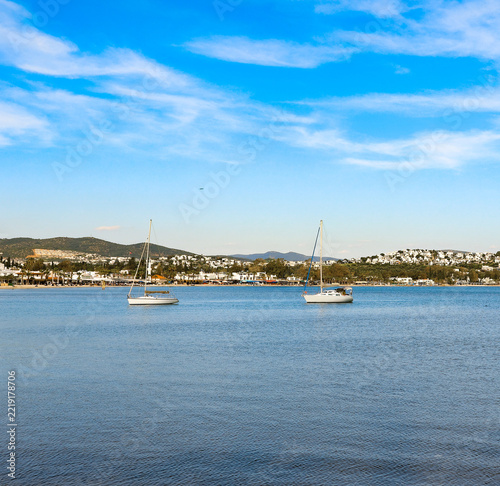 Sailboats floating on clear water, offering a peaceful scene of the Bodrum coast, inviting relaxation and summer travel