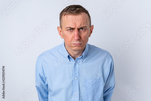 Fotografie Mature man in business casual with a deeply furrowed brow and scowl, conveying a