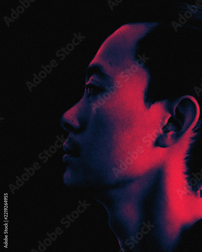 Asian man profile portrait with neon red and blue dual lighting effect