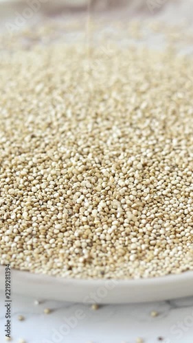 Raw quinoa seeds. Vertical video.