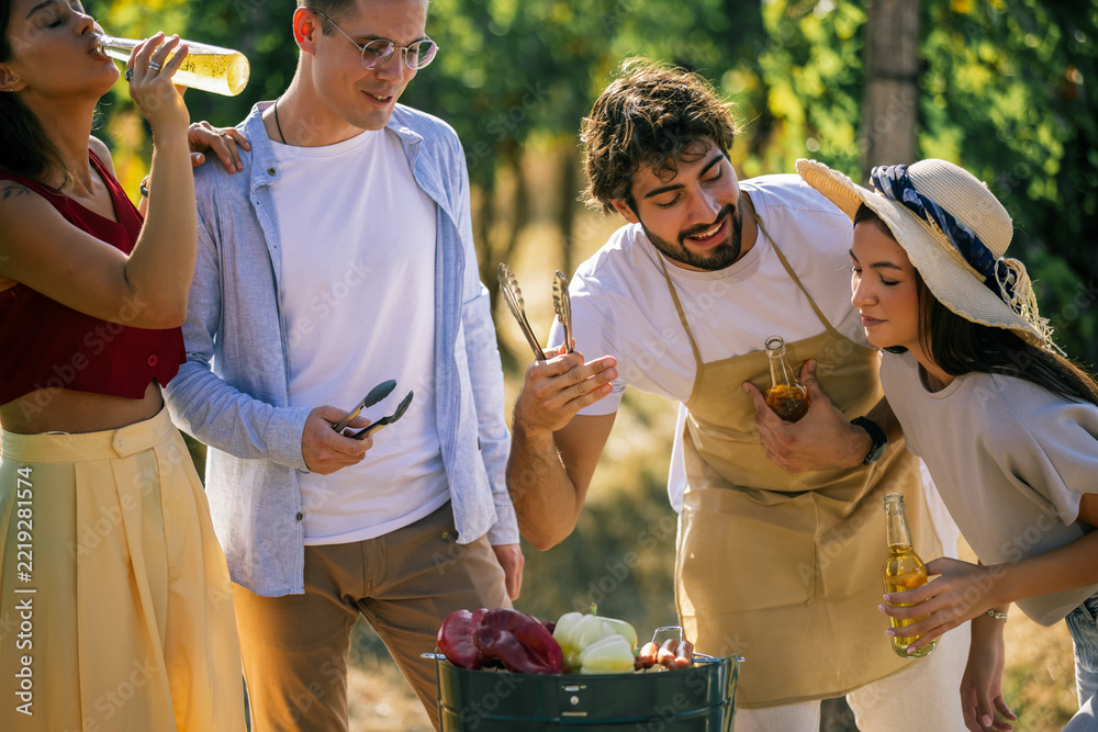 Fototapeta premium Friends working together to prepare food during an outdoor vineyard event
