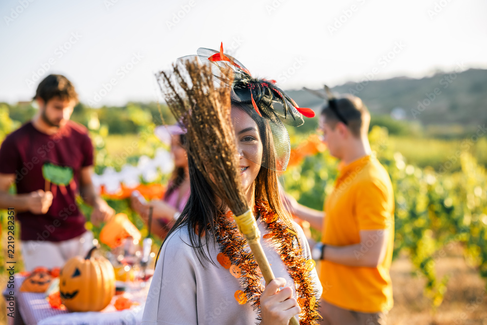 Fototapeta premium Woman wearing a festive Halloween headpiece at a vineyard celebration