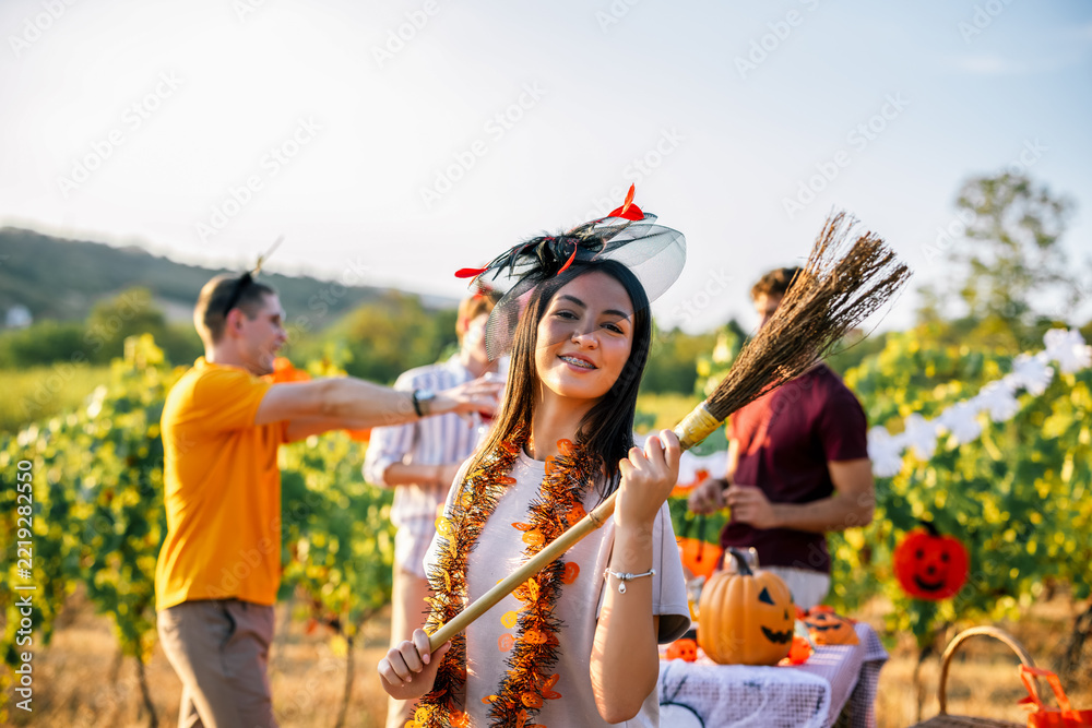 Fototapeta premium Woman smiling in a Halloween costume during an outdoor vineyard party