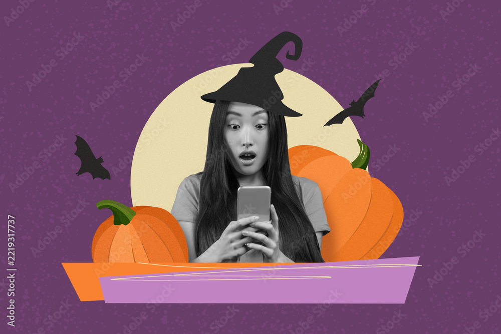 Fototapeta premium Surprised Asian Woman With Long Dark Hair In Witch Hat Holding Smartphone, Engaged In Interaction, With Pumpkins In Background, Celebrating Halloween In Festive Atmosphere.