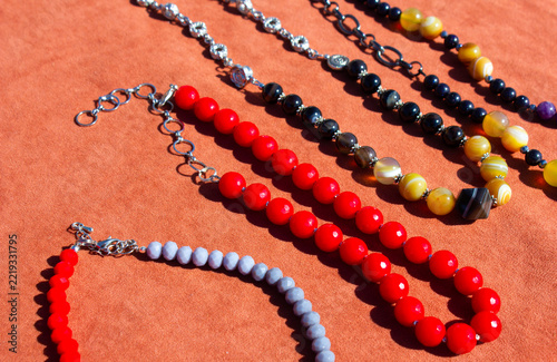 Women necklaces made of natural stones. Necklaces made of red and dark stones.
