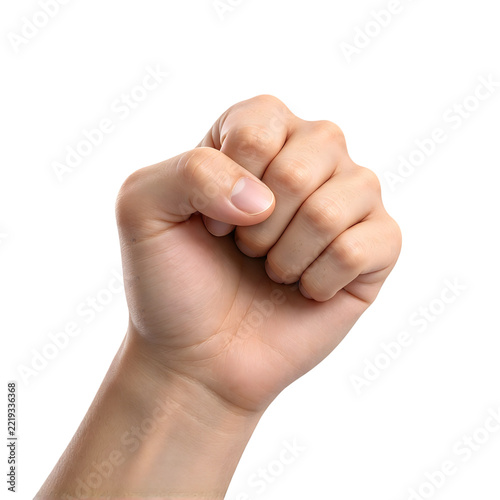 Close up of a clenched fist with thumb tucked in against a white background