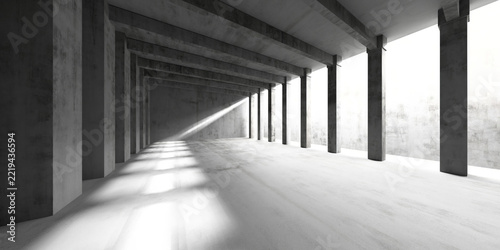 Empty concrete industrial interior with sunlight beams and rows of columns for architectural background and industrial design use