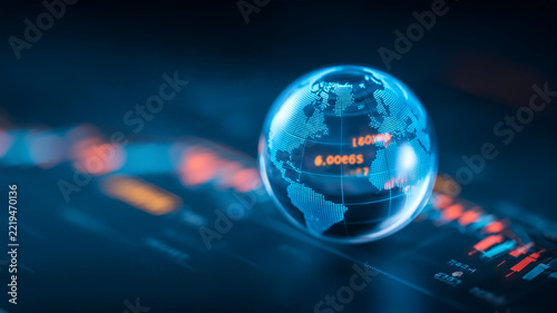 A digital globe displayed over financial market data represents global trading economic analysis and international investment.
