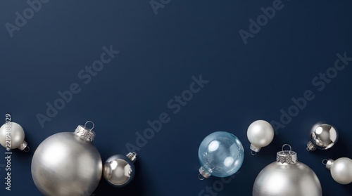Floating silver and clear christmas ornaments isolated on white background