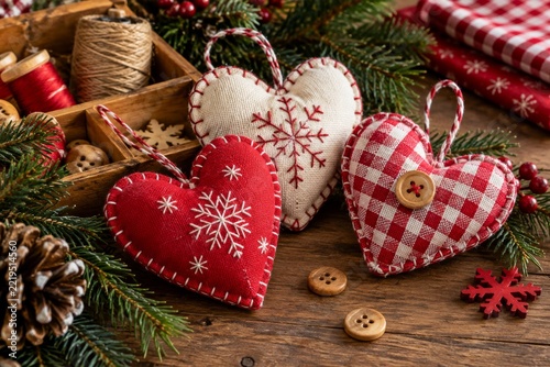 Handmade fabric heart ornaments with festive embroidery