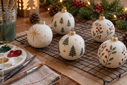 Hand painted Christmas baubles with trees and festive patterns