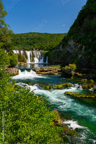 Cascading terraces of Strbacki Buk waterfall flowing through emerald river, Bosnia