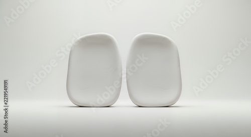 Two Minimalist White Ceramic Plates on a Clean Background.