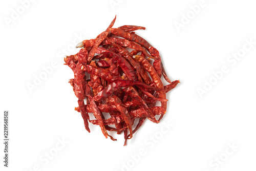 A pile of dried red chilies on a white background.