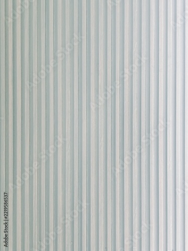 Fluted panel texture displays vertical linear ridges and soft gray shadows in a clean composition.