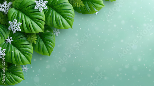Green tropical leaf winter background with snowflakes for seasonal holiday branding design