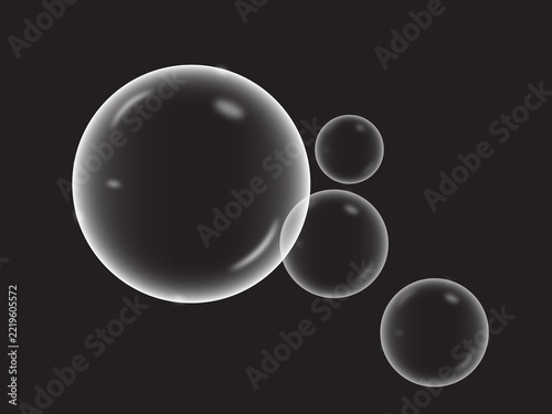 Fotografie Floating soap bubbles on a black background translucent spheres with highlights