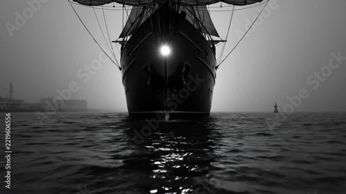 Epic Black and White Shot of a Tall Ship Sailing into the Fog with Majestic Sails on the Ocean