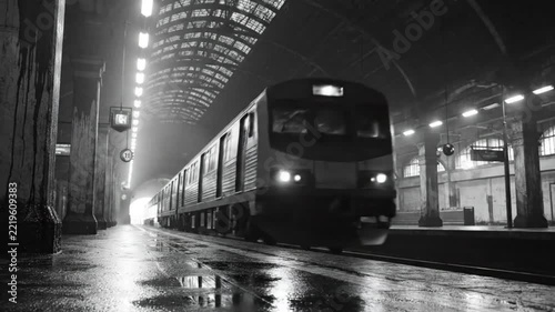 Black and white shot of a passenger train pulling into an old, arched subway station with a bright light at the end of the tunnel