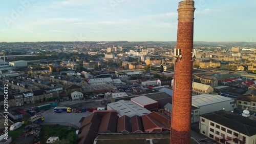 Aerial scenic view of Bradford City Hall and surroundings within city centre, architecture, roads, neighbourhoods, moving cars in sunrise. Drone POV exploration of West Yorkshire county, England, UK.