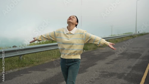 woman walking on a road on mountain in the morning