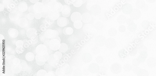Soft white bokeh background with glowing circles for festive holiday