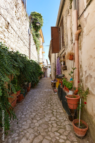 A narrow street winding between the old buildings of Montesarchio, a medieval town in southern Italy.