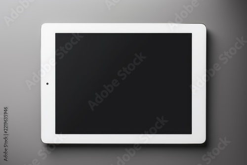 White digital tablet with blank black screen offering a clean canvas for app displays, website interfaces, or creative design mockups, presented on a dark gray background