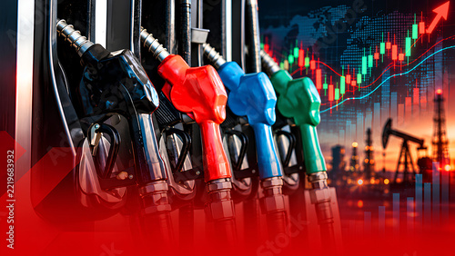 Fuel nozzles and rising market charts suggest higher energy prices and demand.