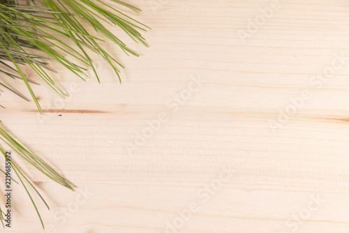 Pine leaves a light wood background