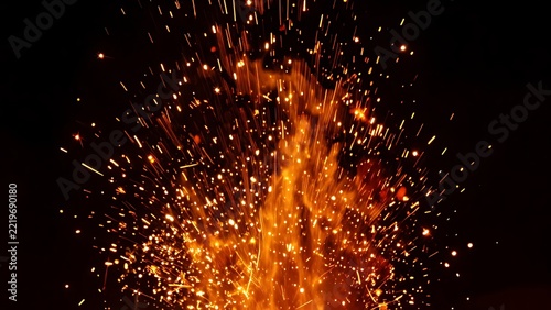 Embers drift high into the night.