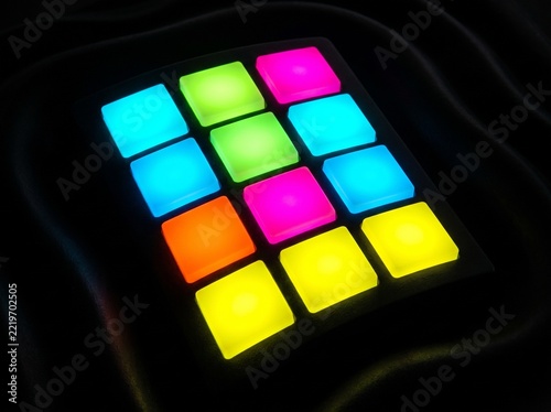 Vibrant Illuminated Music Production Pads on Dark Fabric Background