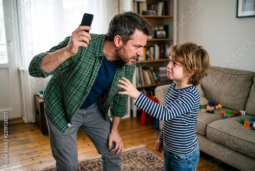 Father disciplining crying boy about smartphone screen time