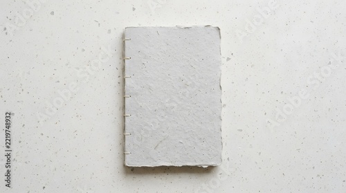 A high quality top view book mockup featuring a clean white hardcover book isolated on a light gray background surface